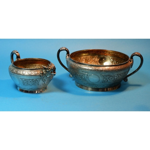 375 - A 19th century sugar bowl and cream jug with extensive chased relief decoration in the Indian manner... 