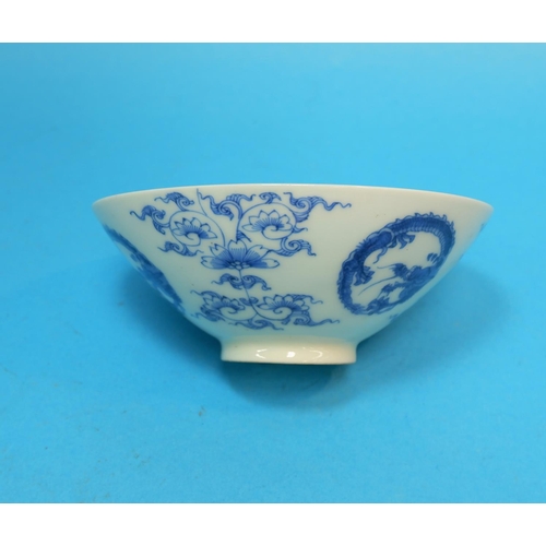 233 - A Chinese porcelain blue and white rice bowl decorated with dragons, exotic trees etc, on raised foo... 