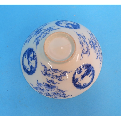 233 - A Chinese porcelain blue and white rice bowl decorated with dragons, exotic trees etc, on raised foo... 