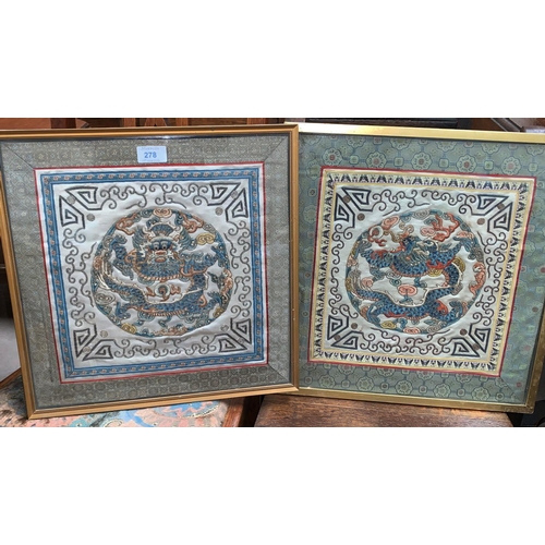 278 - A pair of embroidered silk Chinese panels depicting dragons