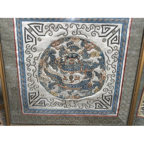 278 - A pair of embroidered silk Chinese panels depicting dragons