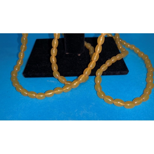 313B - A butterscotch amber coloured long necklace of small beads, weight 31gm
NO BIDS SOLD WITH THE NEXT L... 