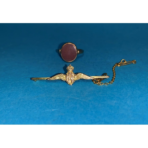 372 - A 9 carat hallmarked gold ring set with a red stone; an RAF bar brooch, stamped '9CT', 4.6 gm gross