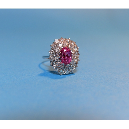 345 - A white metal pink sapphire and diamond cluster dress ring, the central pink stone approximately 3 c... 