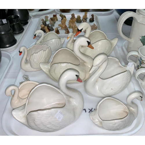 12 - A collection of Wade Whimsies, various pottery swans etc.