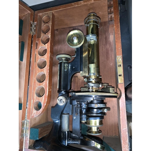 575 - A late 19th  century brass microscope by Swift, London, Serial No 17127, with additional lenses etc