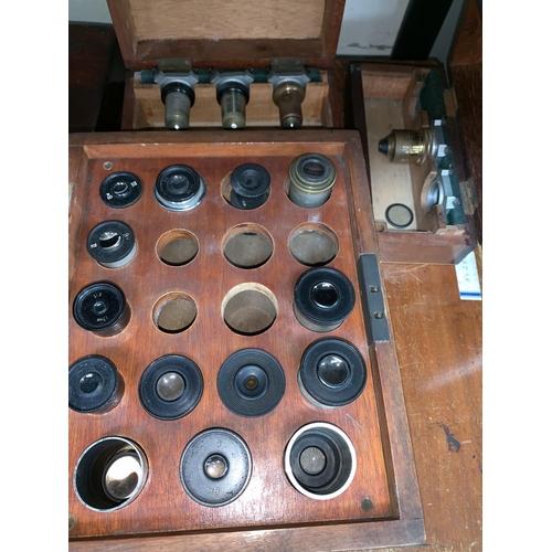 575 - A late 19th  century brass microscope by Swift, London, Serial No 17127, with additional lenses etc