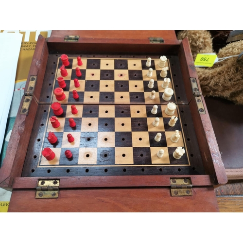 751 - A 19th century mahogany cased folding travelling chess set with bone pieces