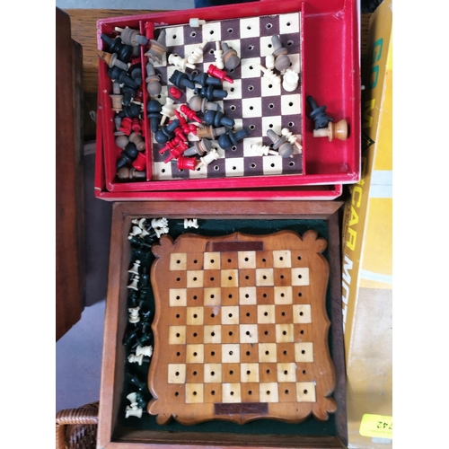 753 - An early 20th century travelling chess set 25cm and another