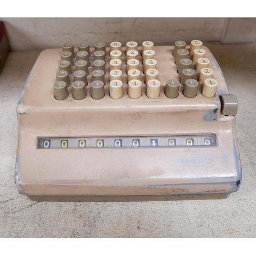 53 - Bells Punch Company adding machine in beige; a similar in beige