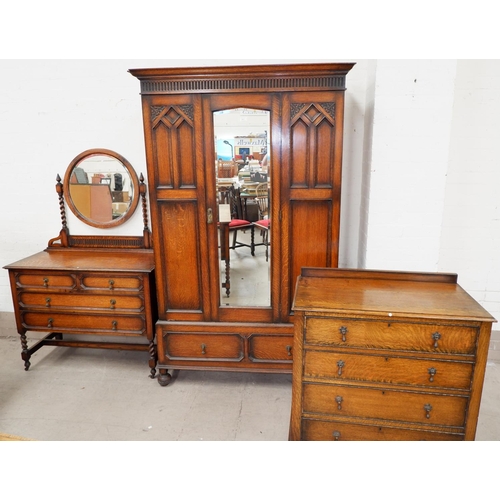 607 - A 1930's golden oak period style bedroom suite comprising mirror door wardrobe, dressing table and w... 