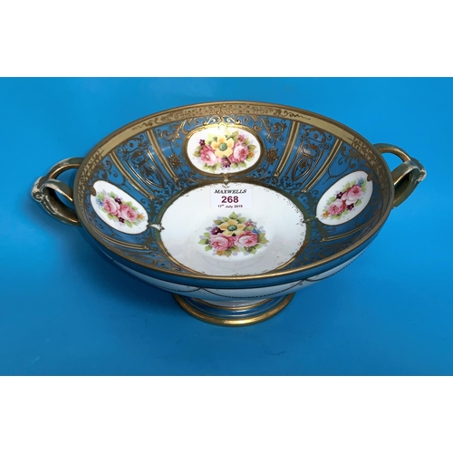 268 - A late 19th/ early 20th century continental porcelain double handled comport decorated in blue and g... 