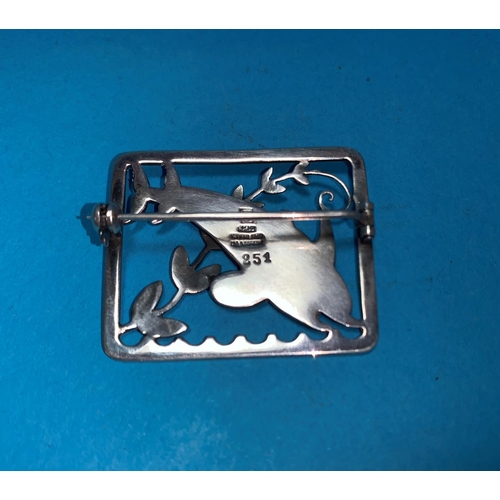 294 - A Danish sterling silver brooch designed by Arno Malinowski for Georg Jensen, with two leaping dolph... 