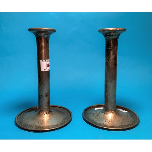 363A - A pair of plain cylindrical silver cased candlesticks, circular base, Sheffield, 1928, 7