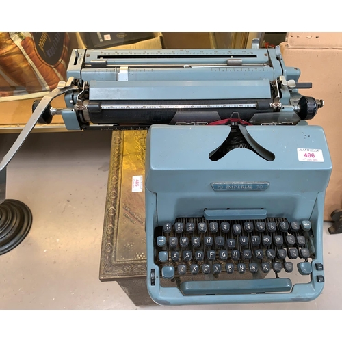 486 - An Imperial manual typewriter; an AEG portable typewriter; a vintage Roberts radio; a slide projecto... 