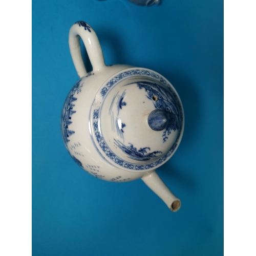 286A - An 18th / 19th century Chinese porcelain teapot decorated in underglaze blue with buildings and tree... 