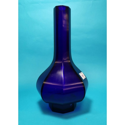 290 - An octagonal baluster deep blue 'Peking' glass vase with tall slender neck and raised foot, incised ... 