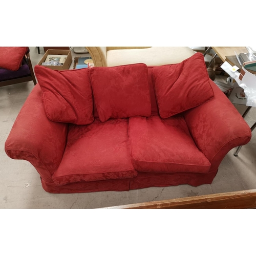 593 - A 2 seater settee in rust coloured fabric