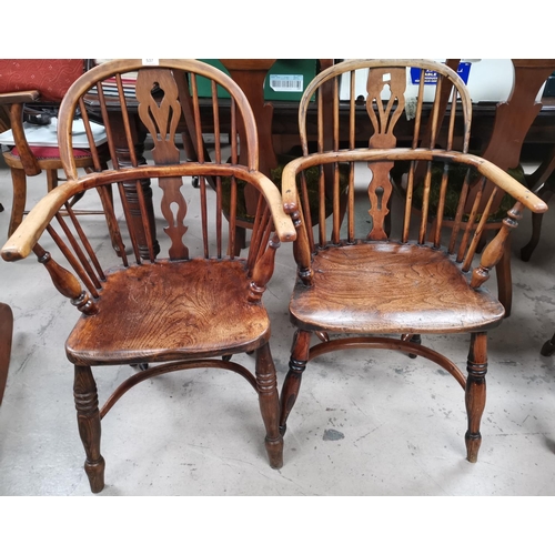 537 - A 19th century near pair of Windsor chairs with low backs and crinoline stretcher