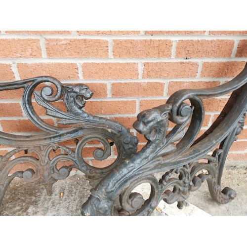 618 - A Victorian pair of cast iron garden bench ends with griffin terminals