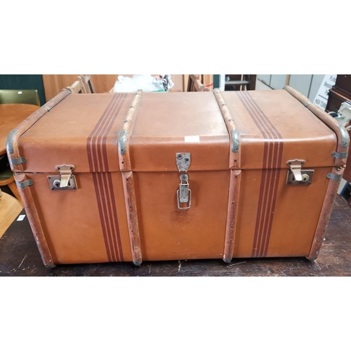 635 - A large canvas cabin trunk, wood bound with interior shelf