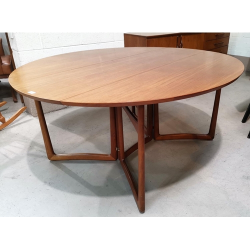 541 - A 1960's teak dining suite comprising oval drop leaf table and 8 chairs,in green fabric, by Charles ... 