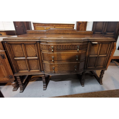 570 - A 1930's Jacobean style carved golden oak dining suite on square carved legs, comprising draw leaf t... 