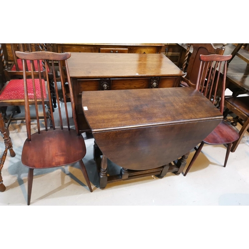606 - An oak drop leaf dining table with oval top, on gate legs; a set of 4 Ercol style stick back chairs