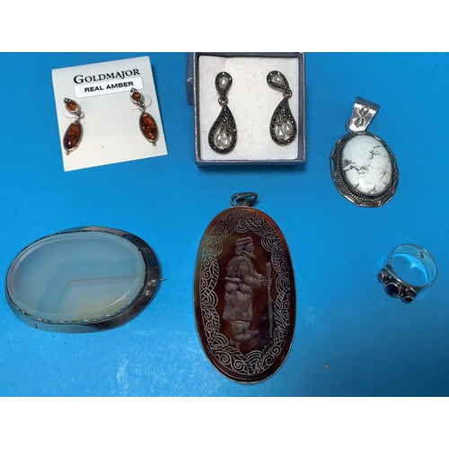296 - An oval brown hardstone pendant with intaglio figure of a man with staff; a white metal and marbled ... 