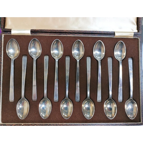 353 - A set of 12 hallmarked silver teaspoons by Walker & Hall with square stepped terminals, Sheffield 19... 
