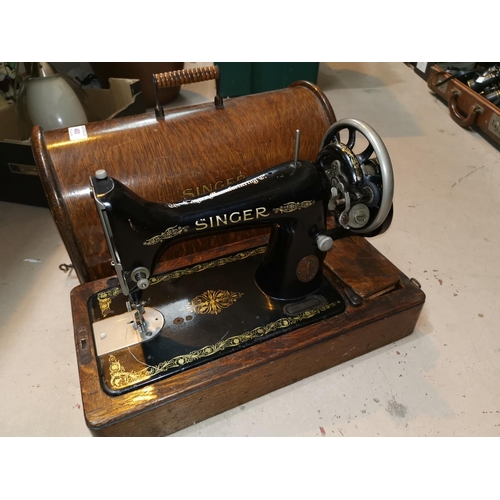 460 - A singer oak cased sewing machine
