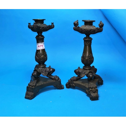 479 - A 19th century pair of Empire style candlesticks with 3 paw feet