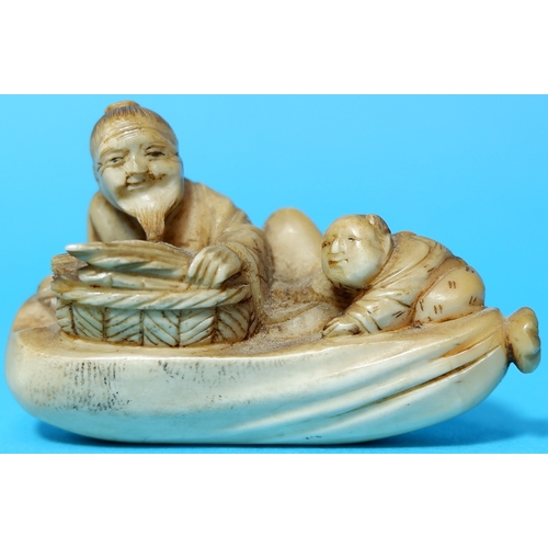 454a - A Meiji period netsuke depicting a man with basket and child, length 6cm