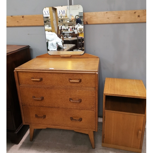 614 - A 1970's G Plan light oak dressing table of 3 drawers; a similar bedside cupboard