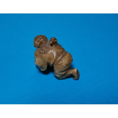456A - A Japanese Meiji peroid ivory Netsuke of a man cleaning a floor with a rat on his back
