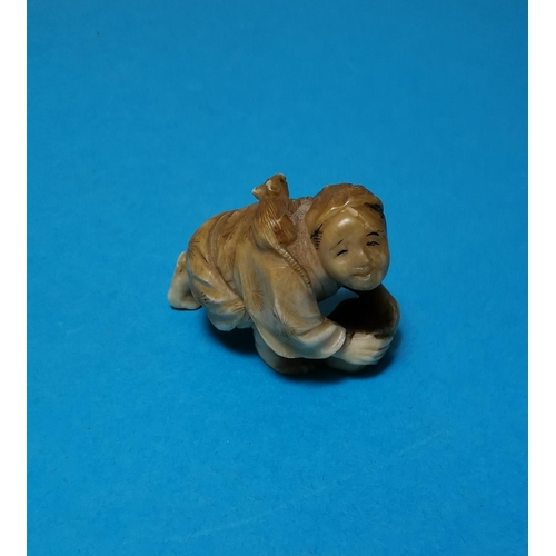 456A - A Japanese Meiji peroid ivory Netsuke of a man cleaning a floor with a rat on his back