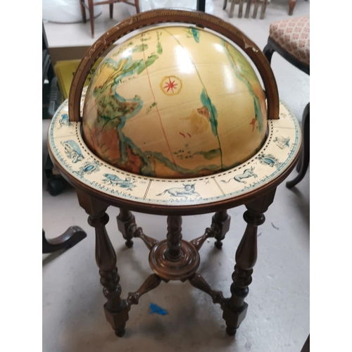 546 - A reproduction globe on stand, with hand painted effect decoration, with zodiac signs to base