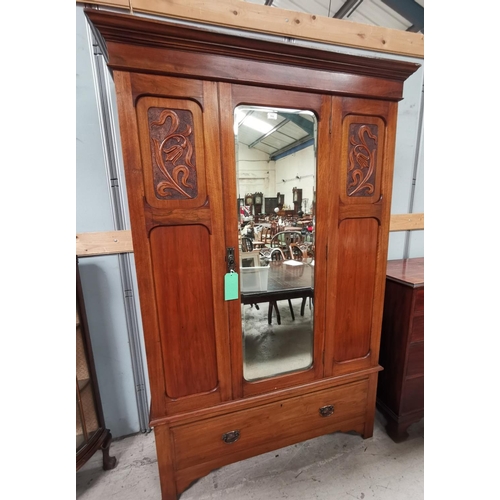 592 - An Edwardian single mirror door wardrobe with drawer to base
