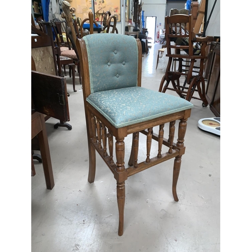 551 - An Edwardian music chair with spindle gallery, green brocade upholstered eat and back; a square foot... 