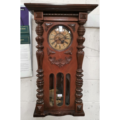 627A - A 19th century walnut cased Vienna wall clock, striking movement, 34