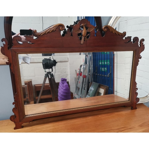 594 - A large early 20th century wall mirror in Chippendale style fretwork frame; a similar smaller mirror
