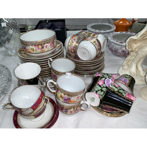 204 - A continental 32 piece part tea service with wide gilt polychrome floral border; 10 pieces of Royal ... 
