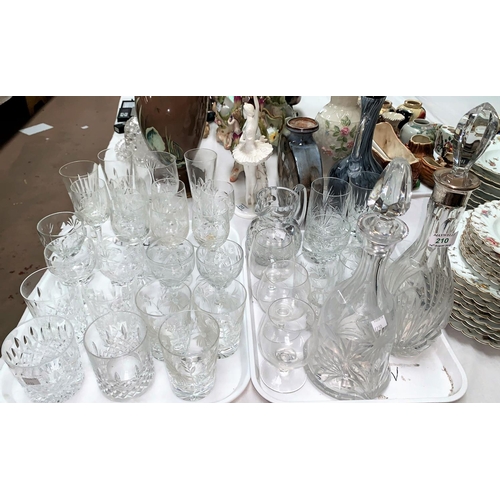 210 - A selection of various cut glass drinking glasses; a decanter with silver rim and another decanter