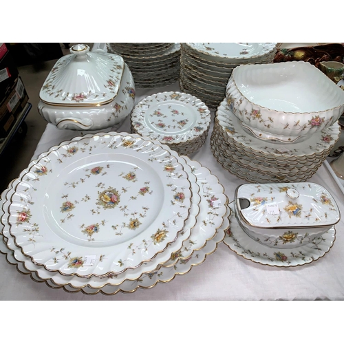 211 - A continental Limoges style large dinner service:  soup tureen and bowls; meat plates; dinner and si... 