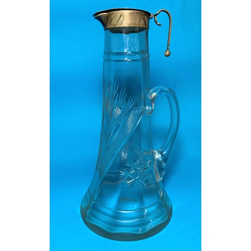 318 - A cut glass claret jug with  hallmarked silver rim and lid, Birmingham 1945
