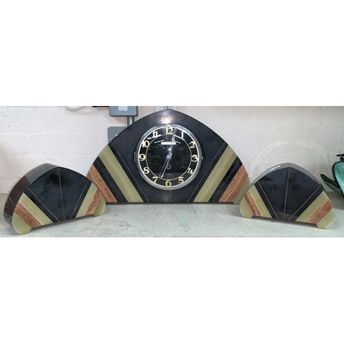 345A - An Art Deco grey marble 3 piece clock garniture, the arched top case and side pieces in-set
with gre... 