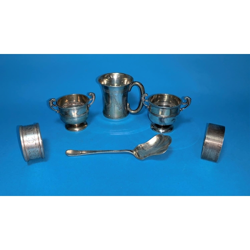 348 - A selection of silver:  a small mug; a pair of miniature trophy cups; 2 napkin rings; etc., various ... 