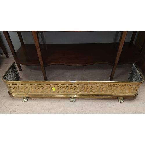 375 - A Victorian pierced brass fender; a Victorin cast iron lion doorstep and a stickstand