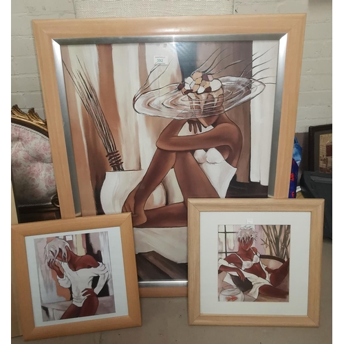 392 - A modern framed print: reclining girl in white swimsuit and fancy hat; 2 similar prints
