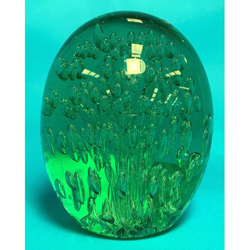 392A - A Victorian green glass “Dumpy” paperweight of ovoid form with elongated internal
bubbles, height 6”